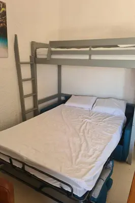 a bed in a room with two bunk beds at Holiday Home Casa zinu mit Blick aufs Meer by Interhome in Cargèse