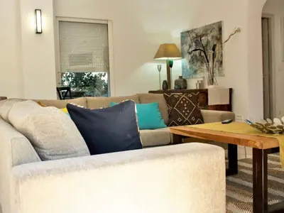 a living room with a couch and a table at Holiday Home Luxusvilla aus Stein Concadoro by Interhome in Porto-Vecchio