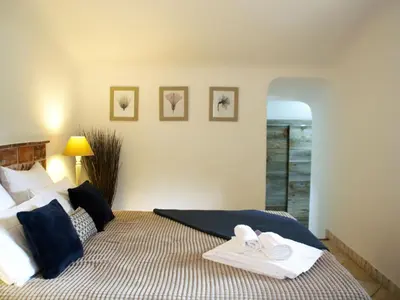 a bedroom with a bed with towels on it at Holiday Home Luxusvilla aus Stein Concadoro by Interhome in Porto-Vecchio