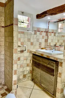 a bathroom with a sink and a mirror at Holiday Home Luxusvilla aus Stein Concadoro by Interhome in Porto-Vecchio