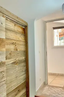a sliding barn door in a living room at Holiday Home Luxusvilla aus Stein Concadoro by Interhome in Porto-Vecchio