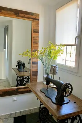 a sewing machine sitting on a wooden table with a mirror at Holiday Home Luxusvilla aus Stein Concadoro by Interhome in Porto-Vecchio