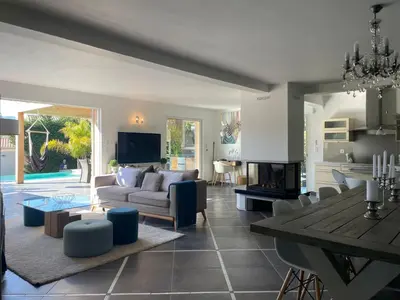 a living room with a couch and a table at Holiday Home Villa Casa Baggia- nahe am Meer mit eigenem Schwimmbad by Interhome in Porto-Vecchio