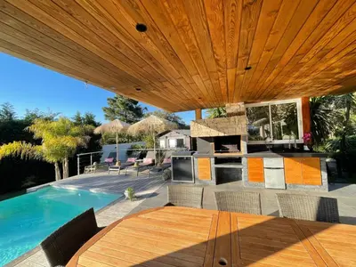 a patio with a table and a swimming pool at Holiday Home Villa Casa Baggia- nahe am Meer mit eigenem Schwimmbad by Interhome in Porto-Vecchio