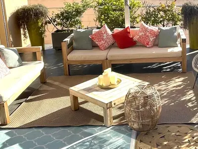 a couch and a coffee table on a patio at Holiday Home Villa Casa Baggia- nahe am Meer mit eigenem Schwimmbad by Interhome in Porto-Vecchio