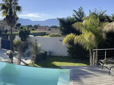 a swimming pool in a yard with a house at Holiday Home Villa Casa Baggia- nahe am Meer mit eigenem Schwimmbad by Interhome in Porto-Vecchio