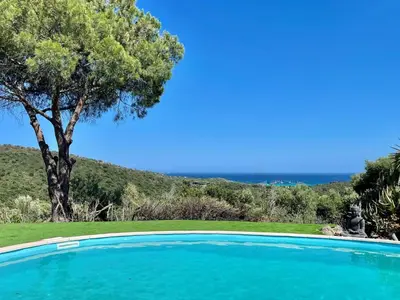 a blue swimming pool with a tree in the background at Holiday Home Ferienvilla Azura mit eigenem Pool by Interhome in Pascialello