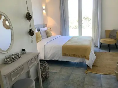 a bedroom with a bed with a mirror and a chair at Holiday Home Ferienvilla Azura mit eigenem Pool by Interhome in Pascialello
