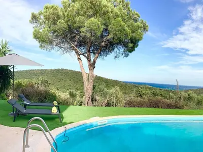 a swimming pool with a tree and a bench next to it at Holiday Home Ferienvilla Azura mit eigenem Pool by Interhome in Pascialello