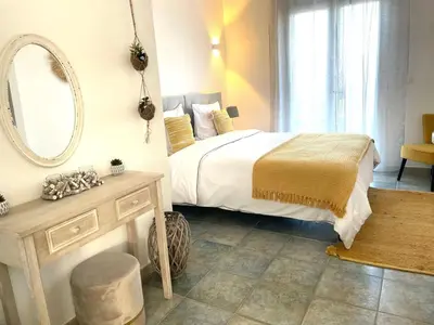 a bedroom with a bed with a mirror and a table at Holiday Home Ferienvilla Azura mit eigenem Pool by Interhome in Pascialello