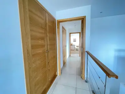a hallway with a wooden door and a staircase at Holiday Home Villa Santa Giulia in Porto-Vecchio by Interhome in Porto-Vecchio