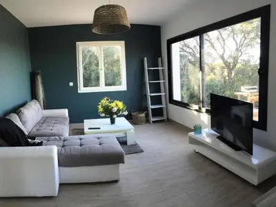 a living room with a couch and a flat screen tv at Holiday Home Villa Belle Vue- direkt am Meer- 1-2 Haustiere erlaubt by Interhome in Cervione