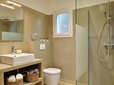 a bathroom with a toilet and a sink and a shower at Holiday Home Villa Belle Vue- direkt am Meer- 1-2 Haustiere erlaubt by Interhome in Cervione