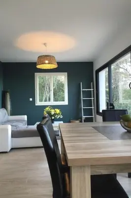 a dining room with a table and a couch at Holiday Home Villa Belle Vue- direkt am Meer- 1-2 Haustiere erlaubt by Interhome in Cervione