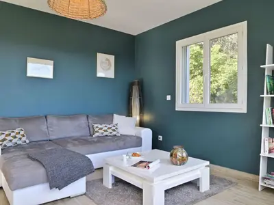 a living room with a couch and a table at Holiday Home Villa Belle Vue- direkt am Meer- 1-2 Haustiere erlaubt by Interhome in Cervione