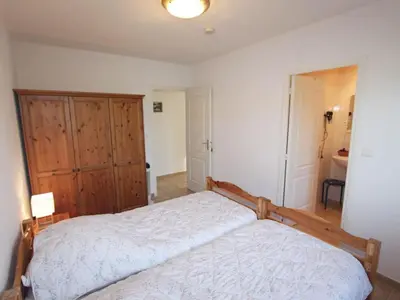 a bedroom with a bed and a wooden cabinet at Holiday Home Villa Miramonte by Interhome in Venzolasca