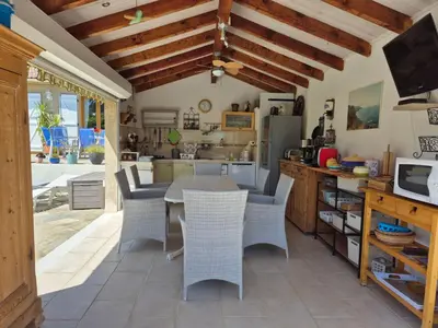 a kitchen with a table and chairs in a kitchen at Holiday Home Villa Miramonte by Interhome in Venzolasca