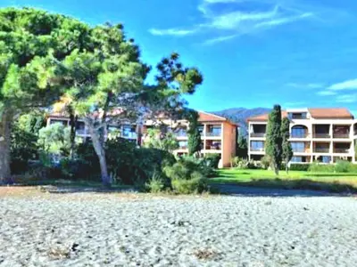 a large apartment building with trees in front of it at Apartment Blaue Flucht Korsika by Interhome in San-Nicolao