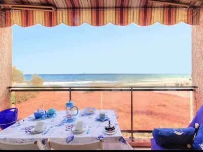 a table in a room with a view of the ocean at Apartment Blaue Flucht Korsika by Interhome in San-Nicolao