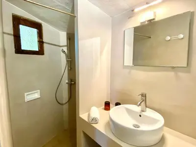 a white bathroom with a sink and a shower at Holiday Home Weingut Punta della Guardia Panorama von Macchia und Meer by Interhome in Cervione