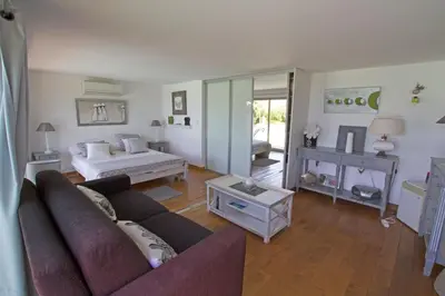a living room with a couch and a bed at Villa Pierretti - Vue mer Panoramique in Coti-Chiavari