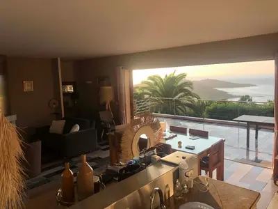 a kitchen with a view of a living room at Villa Pierretti - Vue mer Panoramique in Coti-Chiavari