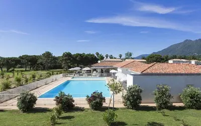 a house with a swimming pool in a yard at Apartment with Garden - Two Pools - Beach Access in Poggio-Mezzana