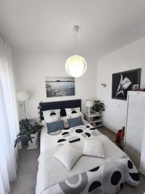 a bedroom with a large bed in a room at Apartment with Garden - Two Pools - Beach Access in Poggio-Mezzana