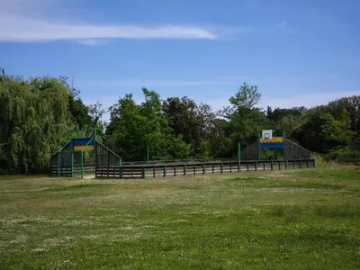 a park with two play structures in a field at Apartment with Garden - Two Pools - Beach Access in Poggio-Mezzana