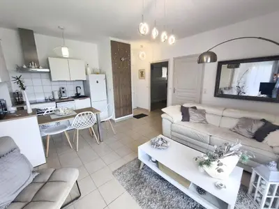 a living room with a couch and a table at Apartment with Garden - Two Pools - Beach Access in Poggio-Mezzana