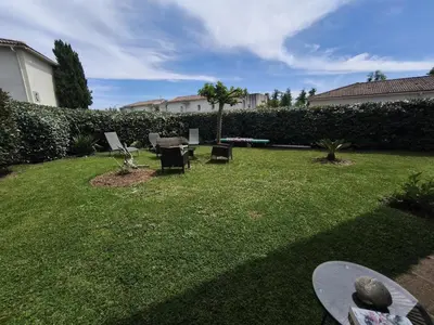 a yard with chairs and a skateboard on the grass at Apartment with Garden - Two Pools - Beach Access in Poggio-Mezzana