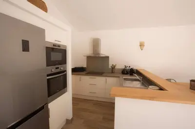 a kitchen with a sink and a stove top oven at Les Bergeries de Porra in Porto-Vecchio