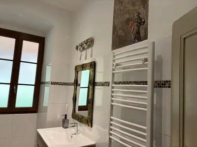 a bathroom with a sink and a mirror at Maison de caractère CASA LECA, piscine privée chauffée in Feliceto