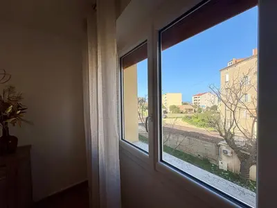 a living room with a couch and a table at Appartement T3 plein centre bord de mer in Propriano