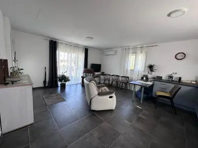 a living room with a couch and a table at Maison in Linguizzetta
