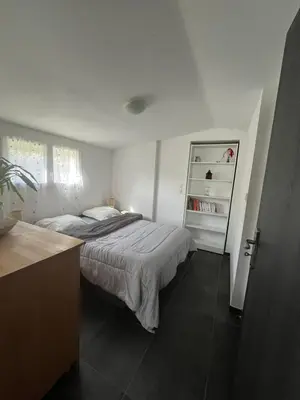 a white bedroom with a bed and a dresser at Maison in Linguizzetta