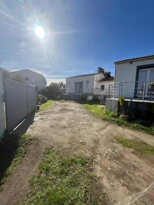 a dirt road with a fence and some buildings at Maison in Linguizzetta