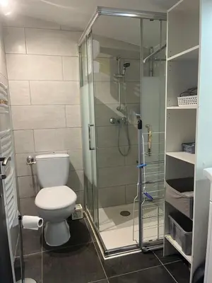 a bathroom with a toilet and a glass shower at Maison in Linguizzetta