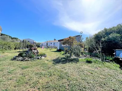 a yard with a house in the background at Maison in Linguizzetta