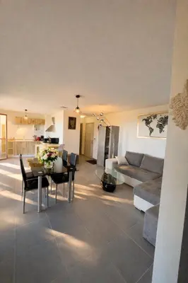 a living room with a couch and a table at L'Immortelle - T3 avec balcon vue mer & montagne in Calenzana