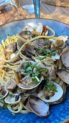 a blue plate of food with oysters and pasta at Appartement dans le coeur de Sartène, la plus corse des villes corses in Sartène