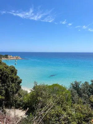 a view of a beach with boats in the water at Maison entre mer et montagne in Conca