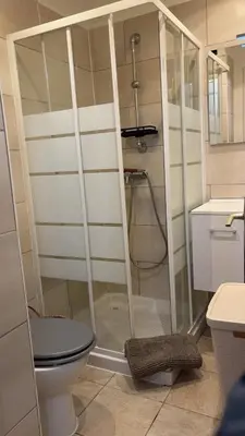 a bathroom with a shower with a toilet and a sink at T2 centre Ajaccio in Ajaccio