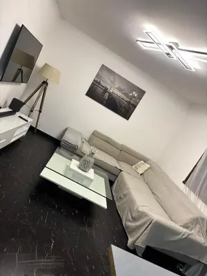 a living room with a couch and a table at T2 centre Ajaccio in Ajaccio