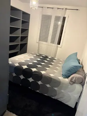 a bedroom with a bed with a black and white comforter at T2 centre Ajaccio in Ajaccio