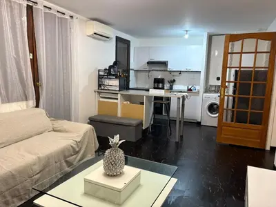 a living room with a couch and a table at T2 centre Ajaccio in Ajaccio