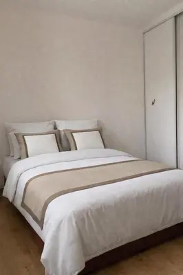 a bedroom with a large bed with white sheets and pillows at Lumineux T3 avec double terrasse au calme - parking sécurisé in Ajaccio