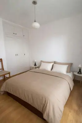 a bedroom with a large bed with blue and white pillows at Lumineux T3 avec double terrasse au calme - parking sécurisé in Ajaccio
