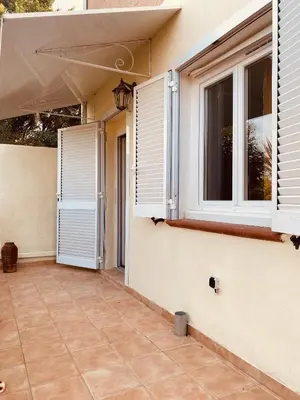 a small tree in front of a house at Charmant T2 en rez-de-jardin in Penta-di-Casinca