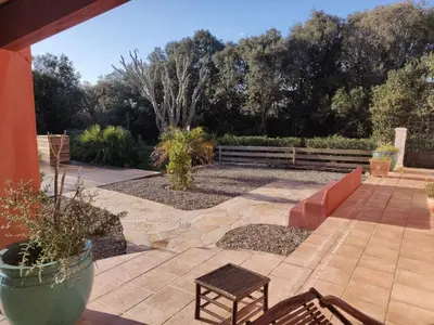 a patio with two chairs and a bench at Villa 140 m2 avec piscine, parc privatif 5000m2 à Bonifacio-Porto Vecchio in Bonifacio